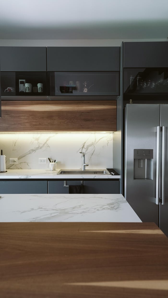 Stylish modern kitchen featuring sleek appliances and marble countertops.